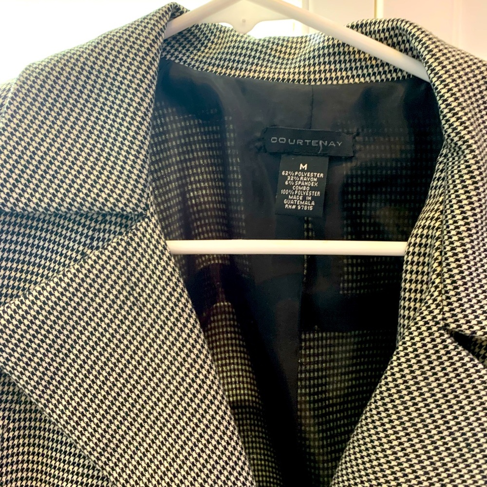 Black and white checkered jacket with cropped sleeves.